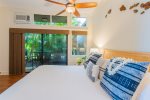 The bedroom features end tables with lamps, a large walk-in closet, fan, AC and a small lanai